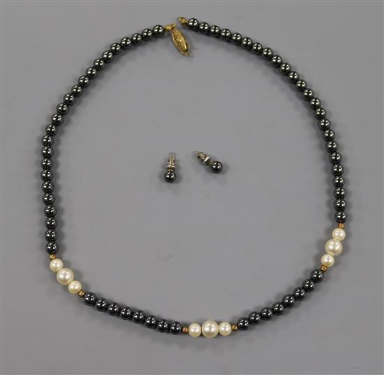 A single strand hematite and simulated pearl necklace and a pair of hematite ear studs.